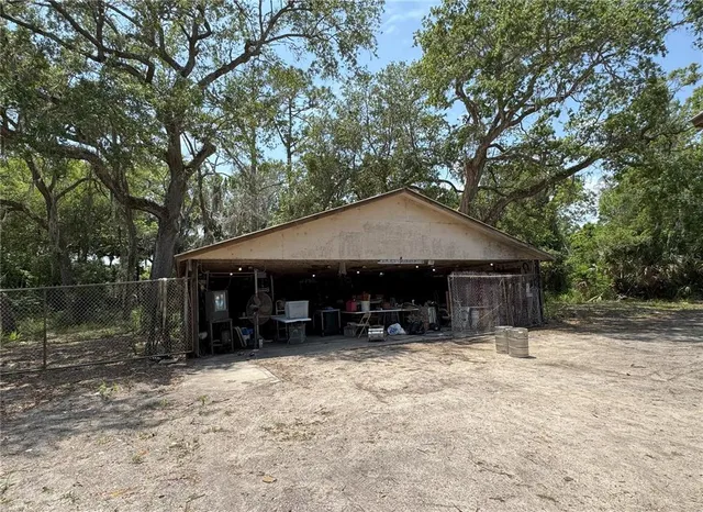 a view of a green field with trees
