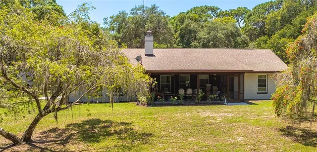 a view of a house with backyard porch and garden