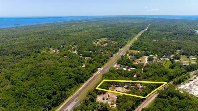 a work room with furniture and floor to ceiling windows