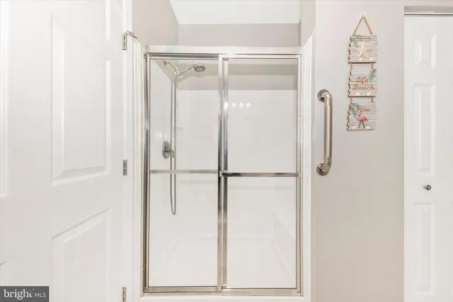 a bathroom with a glass shower door