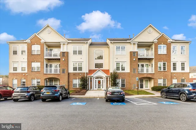 a view of a car park in front of a brick house