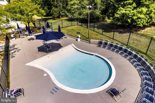 swimming pool view with a seating space