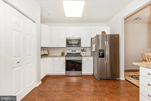 a kitchen with a refrigerator and a stove