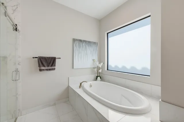 a white bath tub sitting next to a white sink