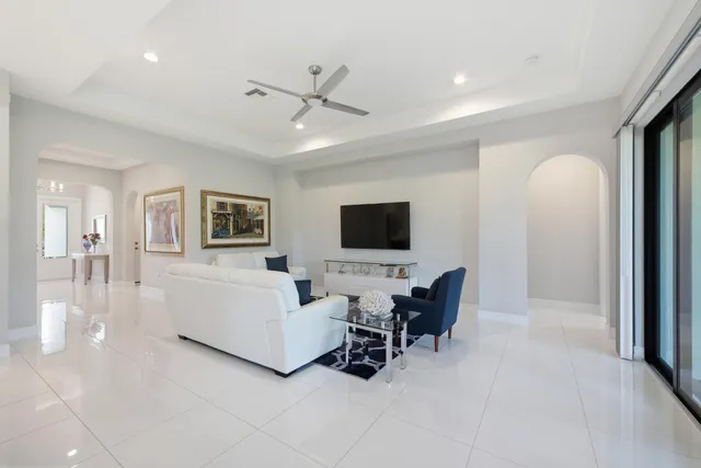 a living room with furniture and view of kitchen