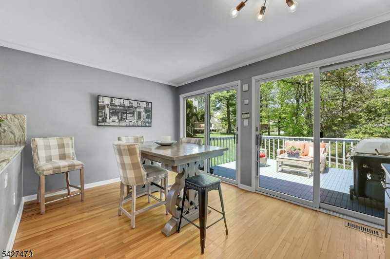 100 Easedale Road, Unit 100 Wayne, NJ 07470 - Photo 18 of 43 a view of a dining room with furniture large windows and wooden floor
