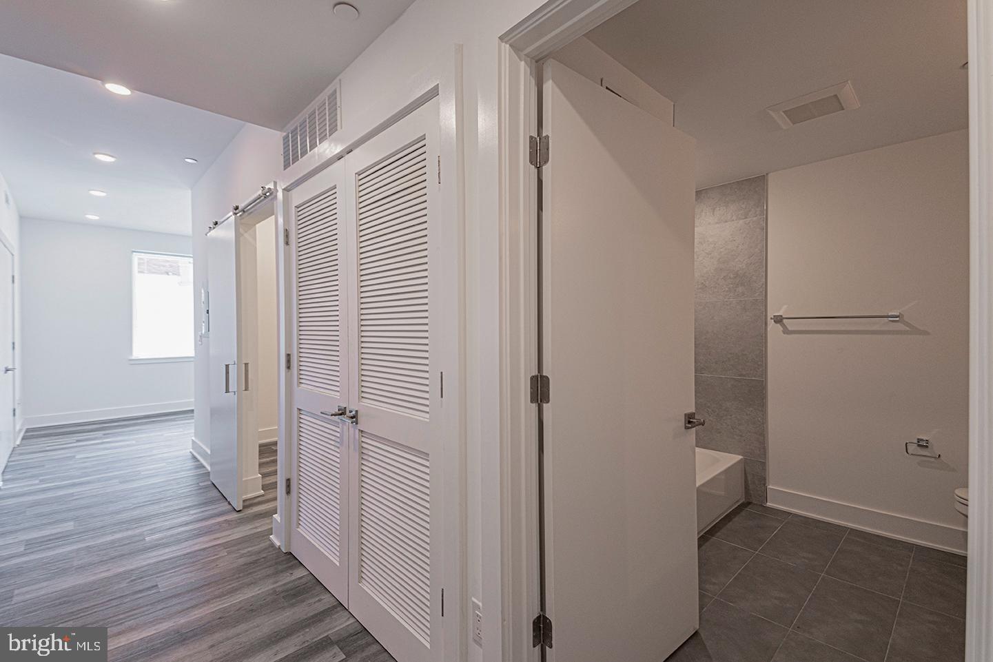 1245 Ridge Avenue, Unit 103 Philadelphia, PA 19123 - Photo 2 of 18 a view of a hallway with wooden floor and closet area