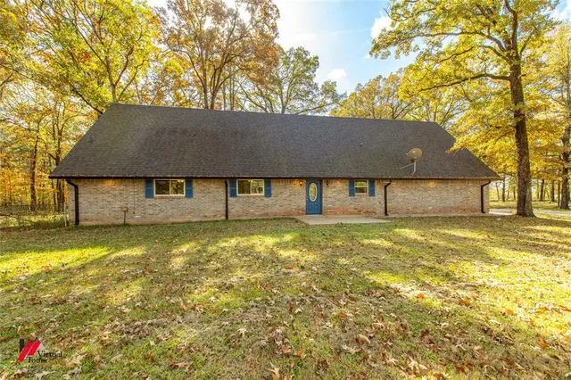 a house with a trees in the background