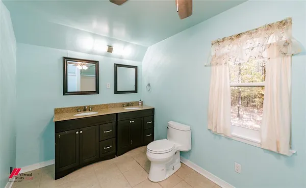 a bathroom with a toilet a sink and mirror