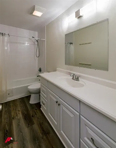 a bathroom with a sink toilet a mirror and shower