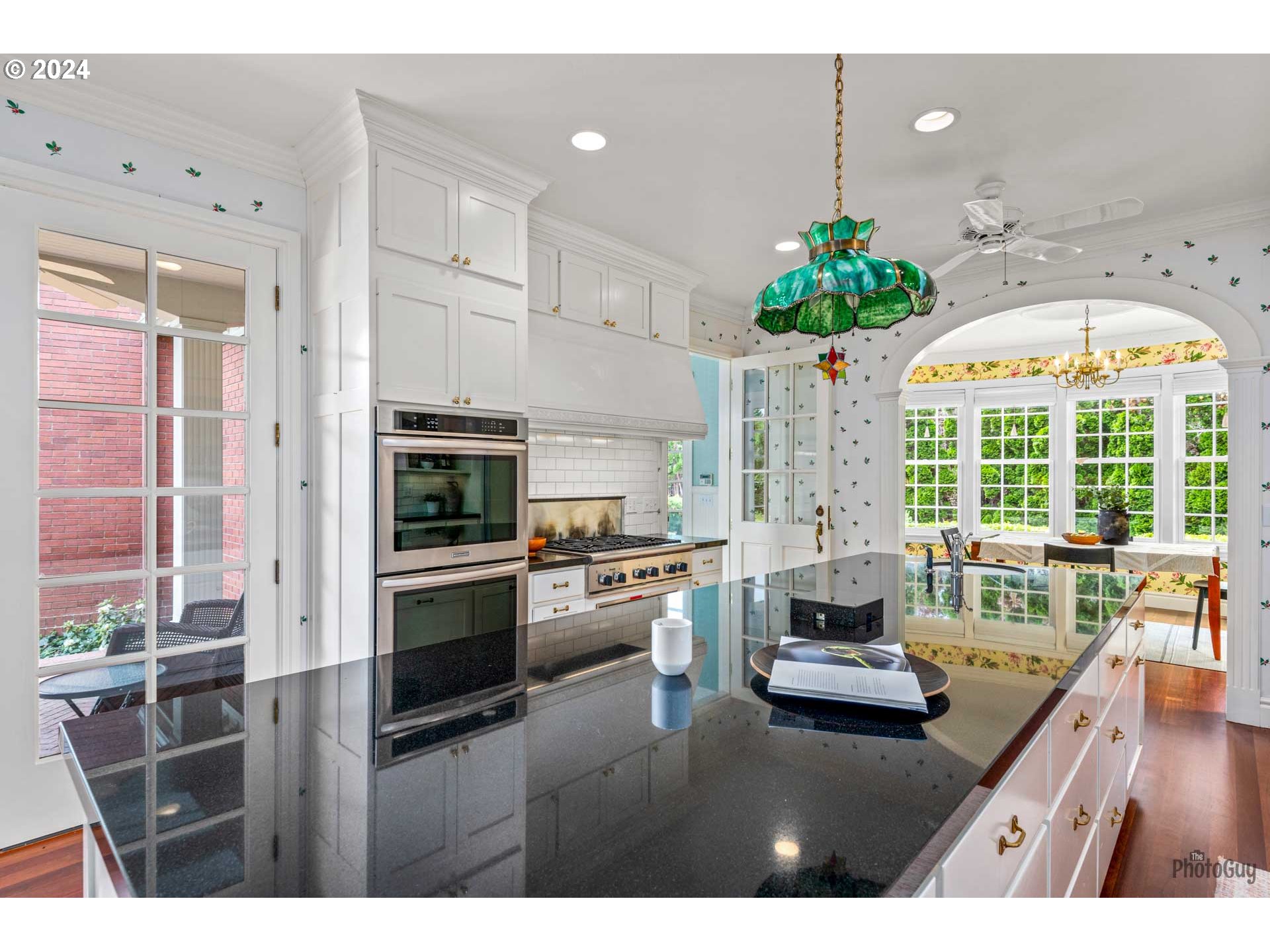 2788 Riverwalk Loop Eugene, OR 97401 - Photo 11 of 48 a kitchen with kitchen island granite countertop a stove and a white cabinets