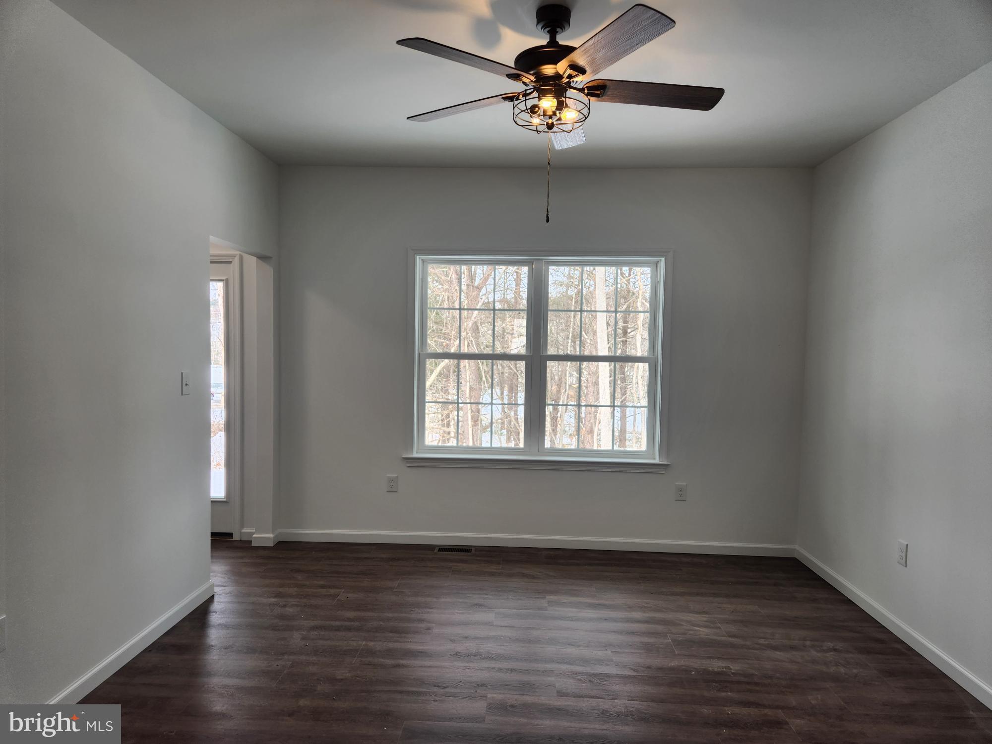 1929 Dunkleberger Road Elliottsburg, PA 17024 - Photo 14 of 48 an empty room with wooden floor chandelier fan and windows