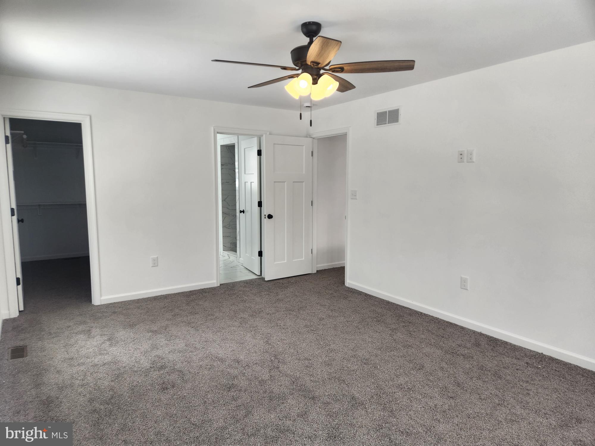 1929 Dunkleberger Road Elliottsburg, PA 17024 - Photo 23 of 48 an empty room with a chandelier fan and a window