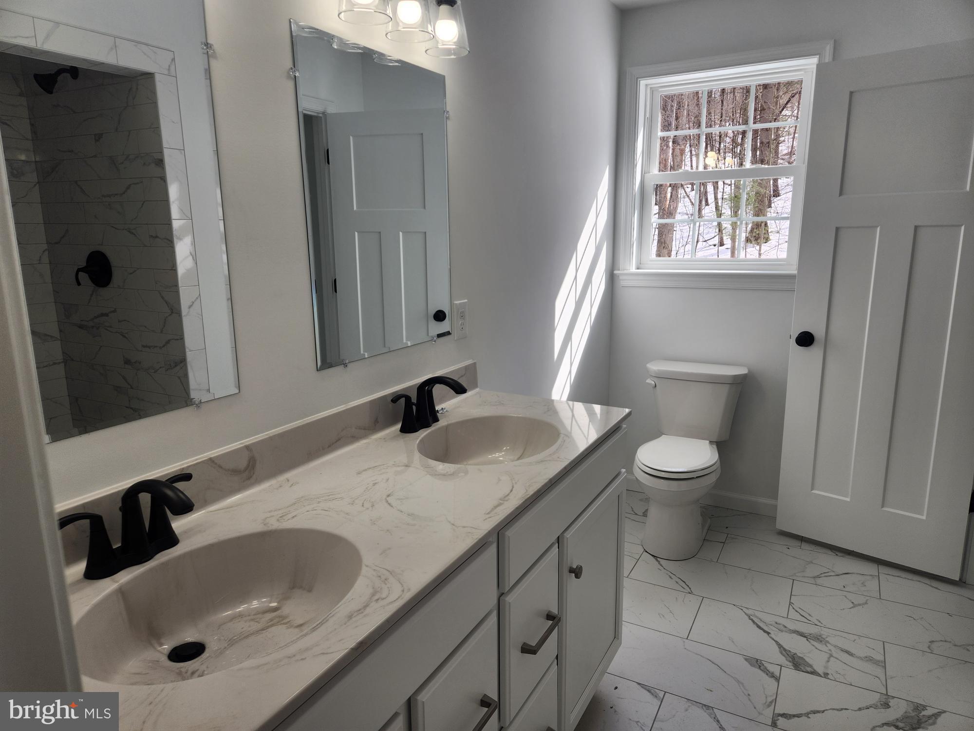 1929 Dunkleberger Road Elliottsburg, PA 17024 - Photo 25 of 48 a bathroom with a granite countertop sink toilet and shower