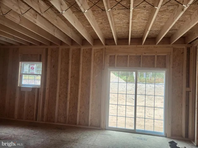a view of a hallway with wooden walls