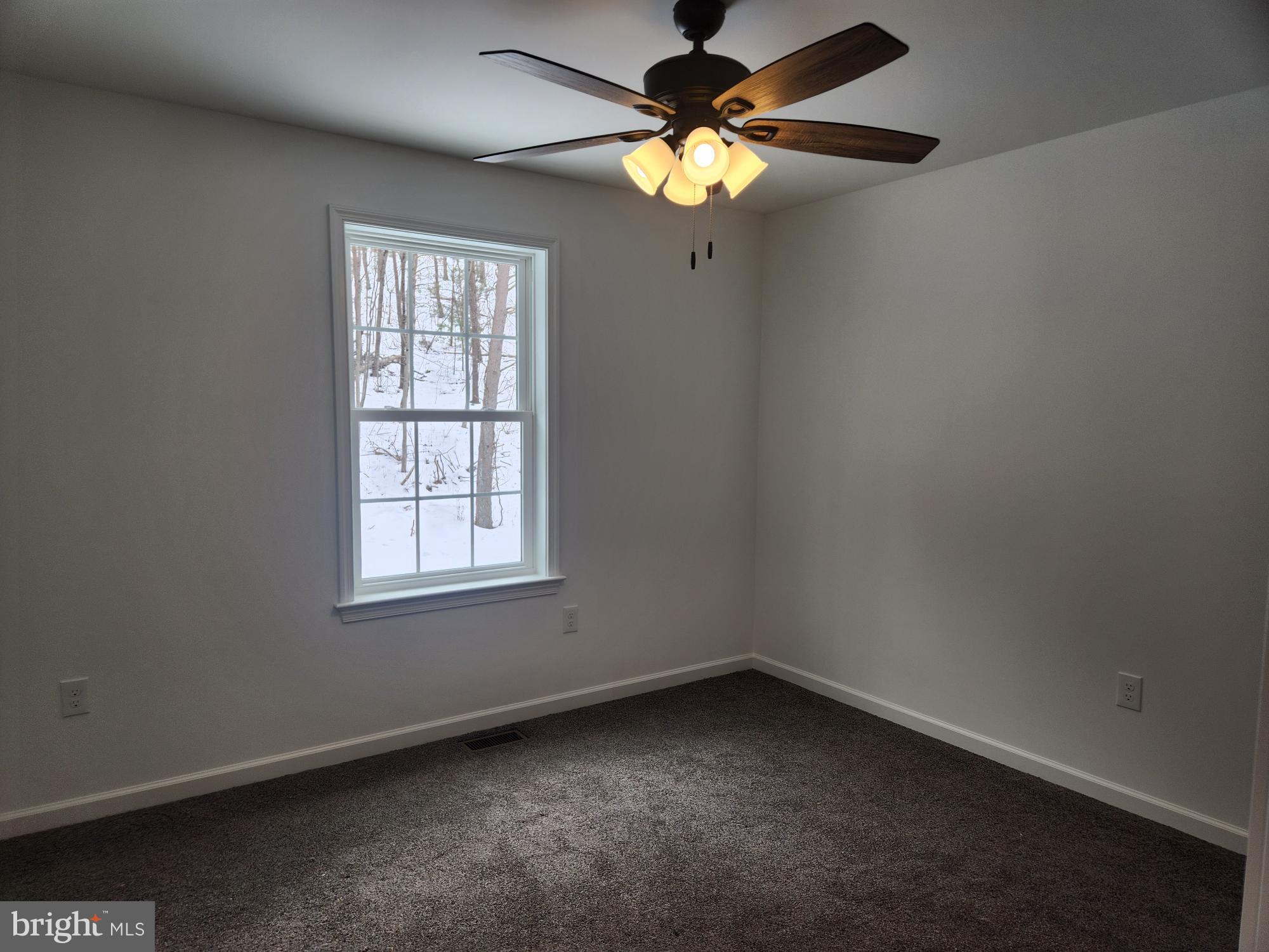 1929 Dunkleberger Road Elliottsburg, PA 17024 - Photo 32 of 48 an empty room with a window and a fan