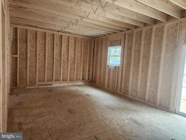 a view of a room with a wooden door