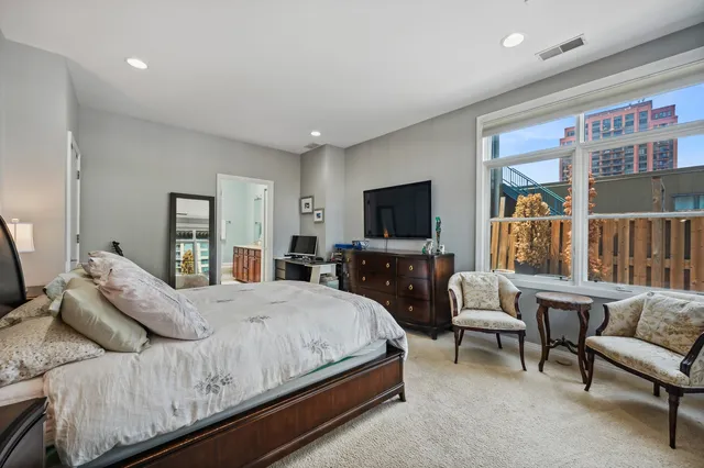 a bedroom with a bed and a flat screen television