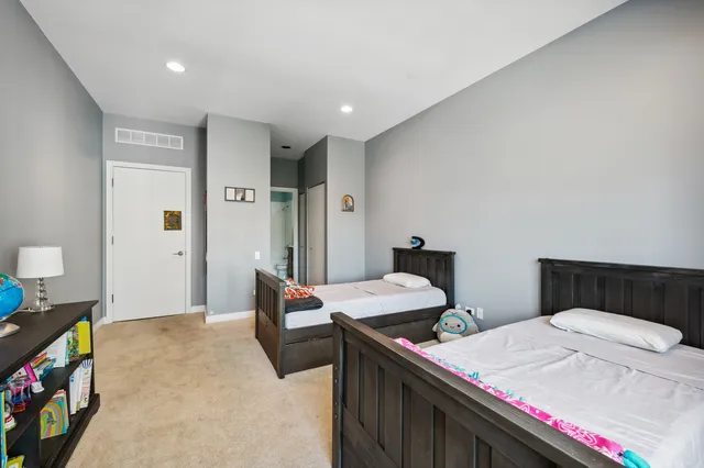 a room with a bed and a dresser in it