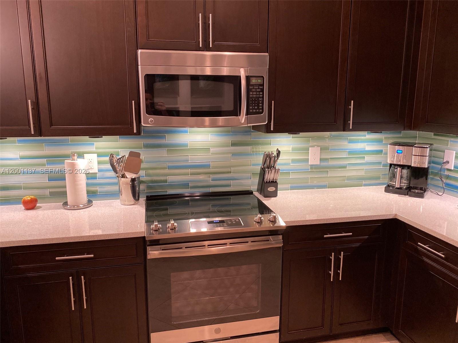 184 West Bay Cedar Circle Jupiter, FL 33458 - Photo 12 of 49 a kitchen with a sink and cabinets