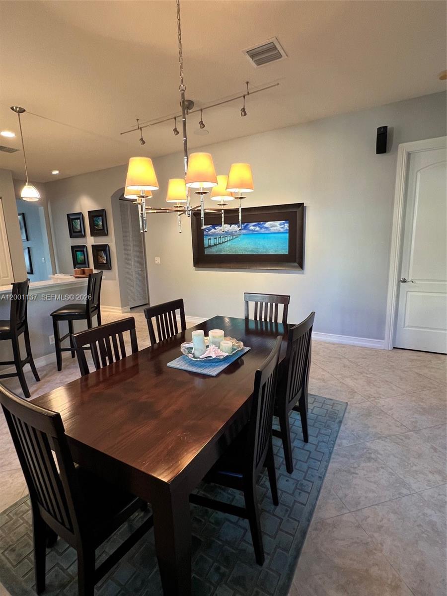 184 West Bay Cedar Circle Jupiter, FL 33458 - Photo 14 of 49 a view of a dining room with furniture