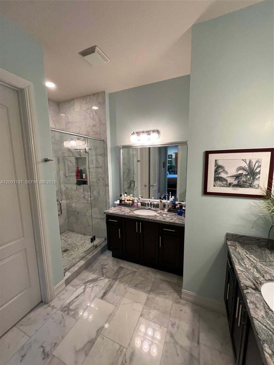 184 West Bay Cedar Circle Jupiter, FL 33458 - Photo 20 of 49 a large bathroom with a glass door shower and sink