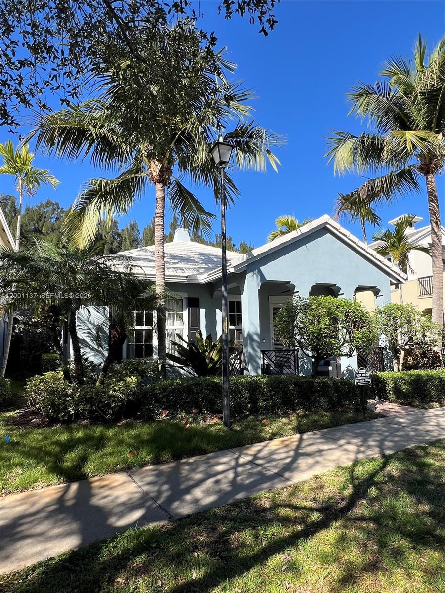184 West Bay Cedar Circle Jupiter, FL 33458 - Photo 2 of 49 a view of a house with a yard and tree s