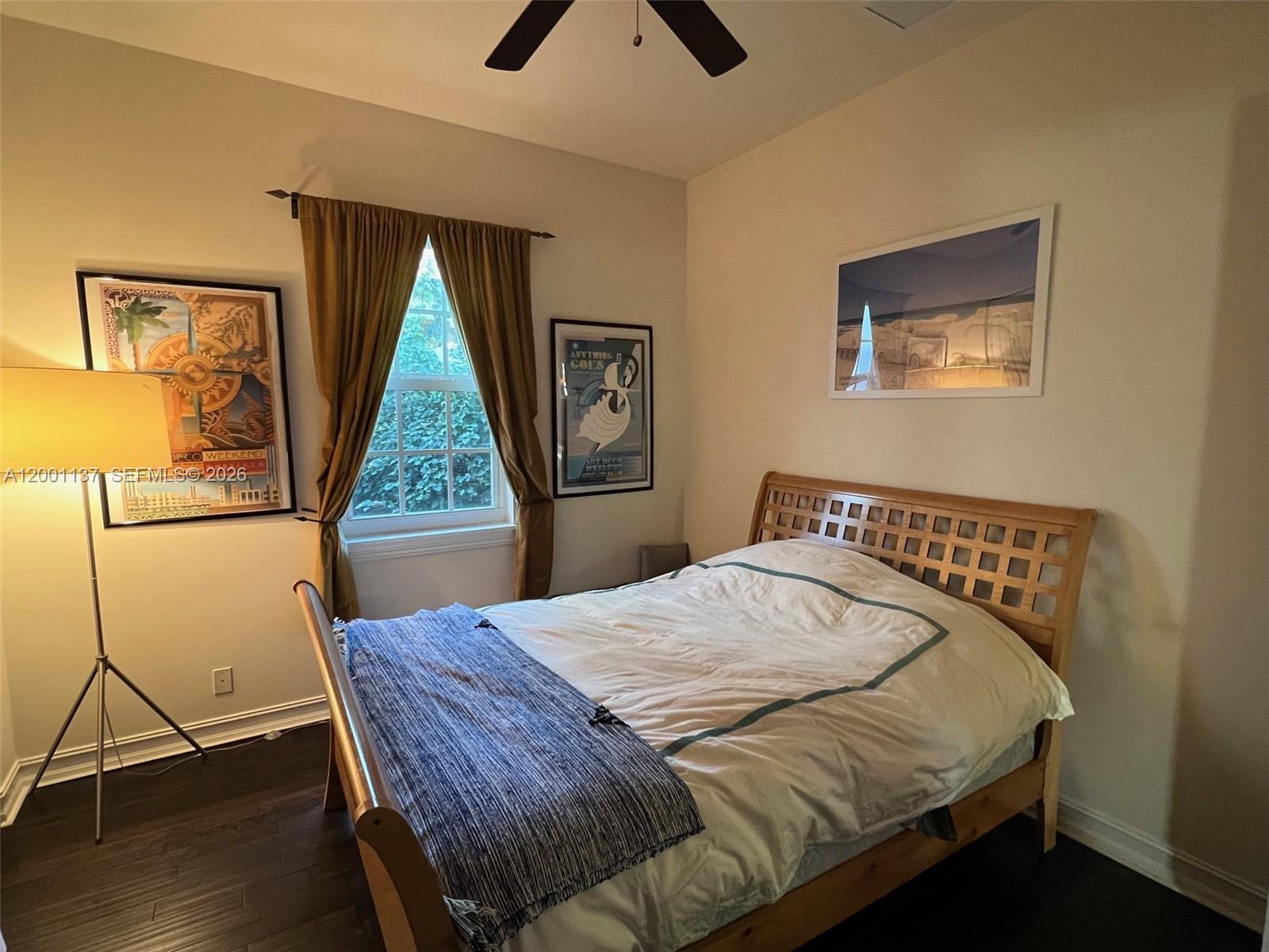 184 West Bay Cedar Circle Jupiter, FL 33458 - Photo 22 of 49 a bed sitting in a bedroom next to a window