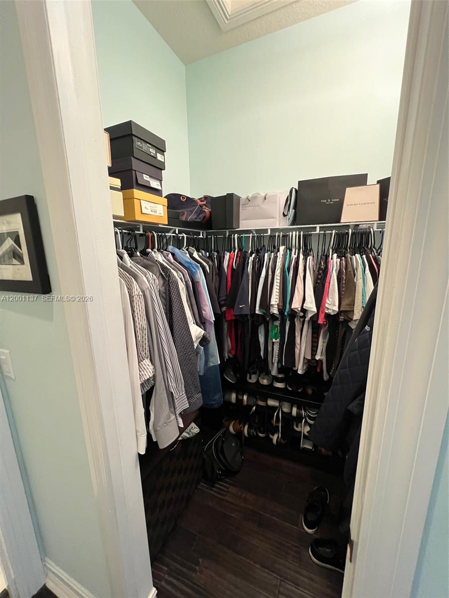 184 West Bay Cedar Circle Jupiter, FL 33458 - Photo 23 of 49 a view of walk in closet with clothes and shoes