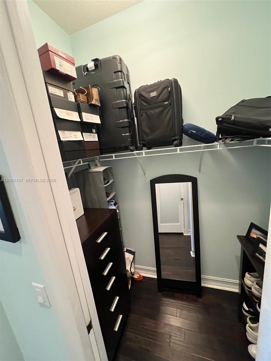 184 West Bay Cedar Circle Jupiter, FL 33458 - Photo 24 of 49 walk in closet with wooden floor and windows