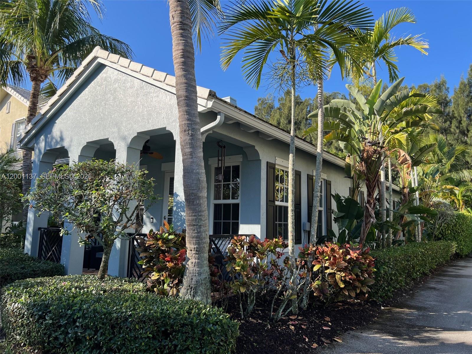 184 West Bay Cedar Circle Jupiter, FL 33458 - Photo 3 of 49 a view of a house with a flower garden