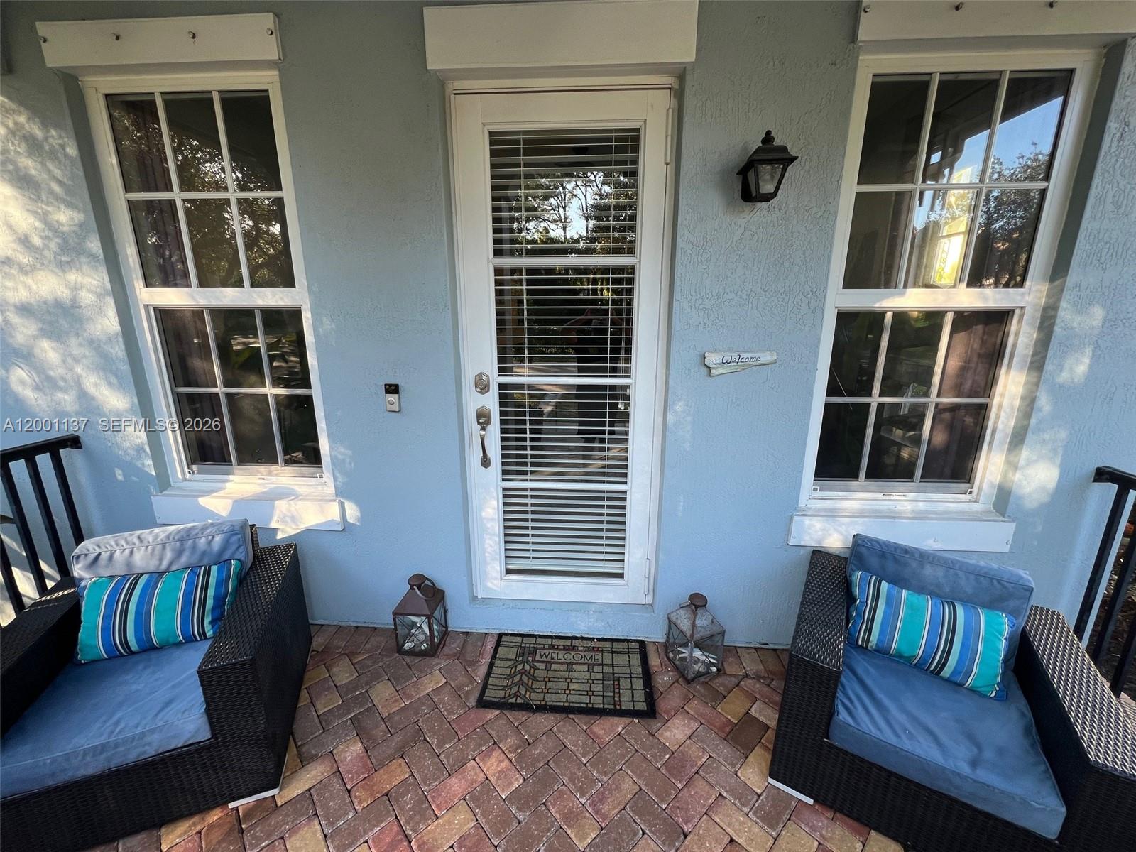 184 West Bay Cedar Circle Jupiter, FL 33458 - Photo 5 of 49 a front view of a house with a large window