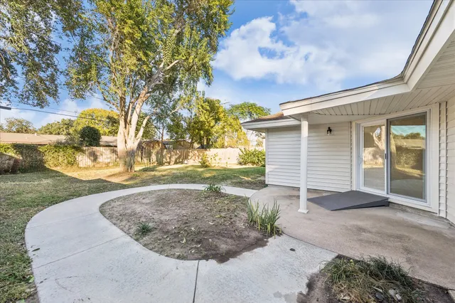 a backyard of a house with large trees