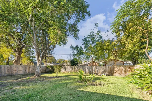 a garden with trees in the background