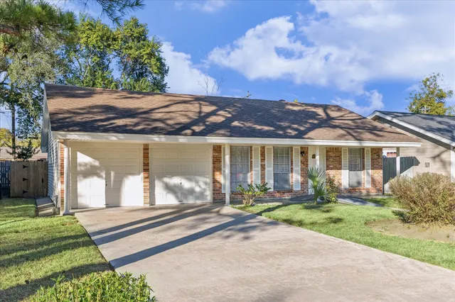 a front view of house with a garden