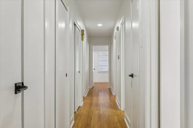 a view of a hallway with wooden floor