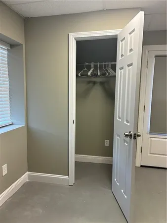 hallway with closet and wooden floor