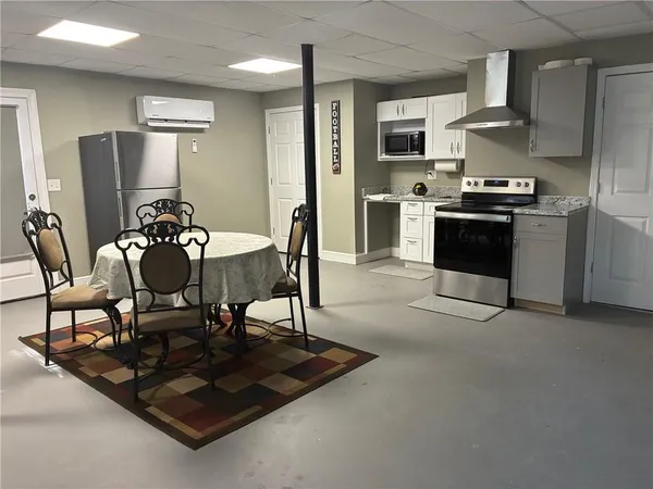 a kitchen with granite countertop a refrigerator and a stove top oven