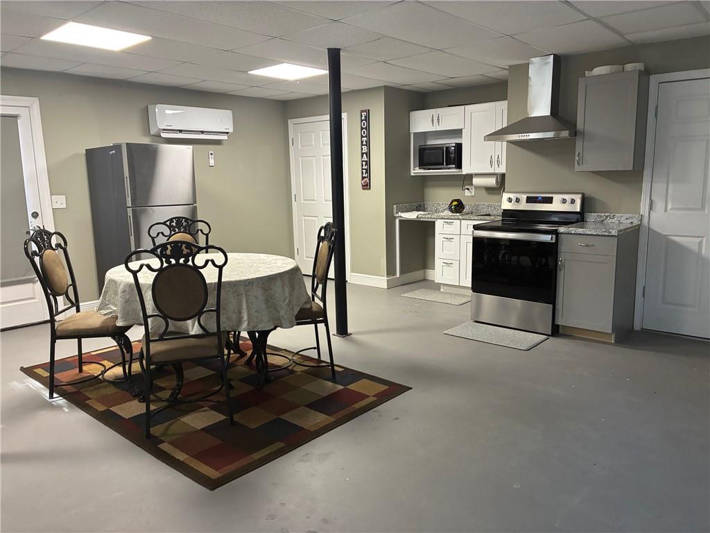 6158 Suwanee Dam Road Sugar Hill, GA 30518 - Photo 5 of 20 a kitchen with granite countertop a refrigerator and a stove top oven