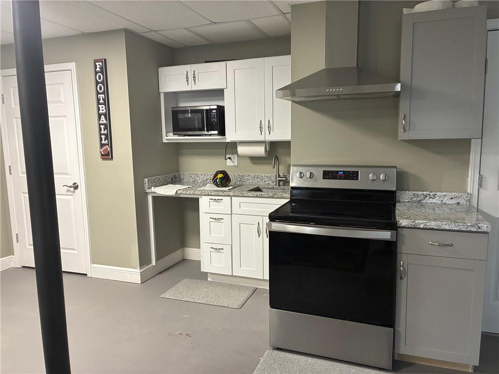 6158 Suwanee Dam Road Sugar Hill, GA 30518 - Photo 6 of 20 a kitchen with stainless steel appliances white cabinets and a stove