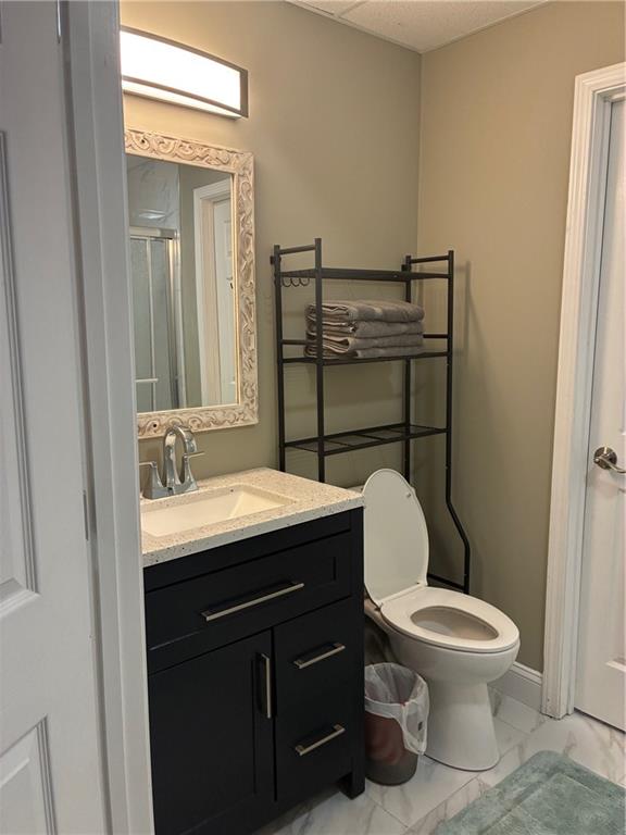 6158 Suwanee Dam Road Sugar Hill, GA 30518 - Photo 9 of 20 a bathroom with a toilet a sink and mirror
