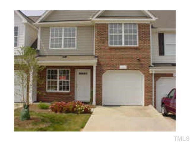 3005 Portrait Drive Cary, NC 27513 - Photo 1 of 6 a front view of a house with a yard and garage