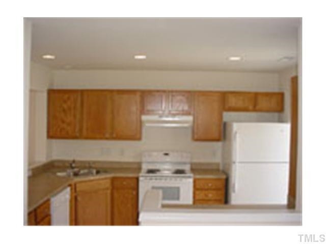 3005 Portrait Drive Cary, NC 27513 - Photo 3 of 6 a kitchen with a refrigerator and a stove