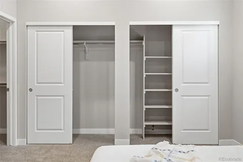 a bedroom with a bed and cabinets