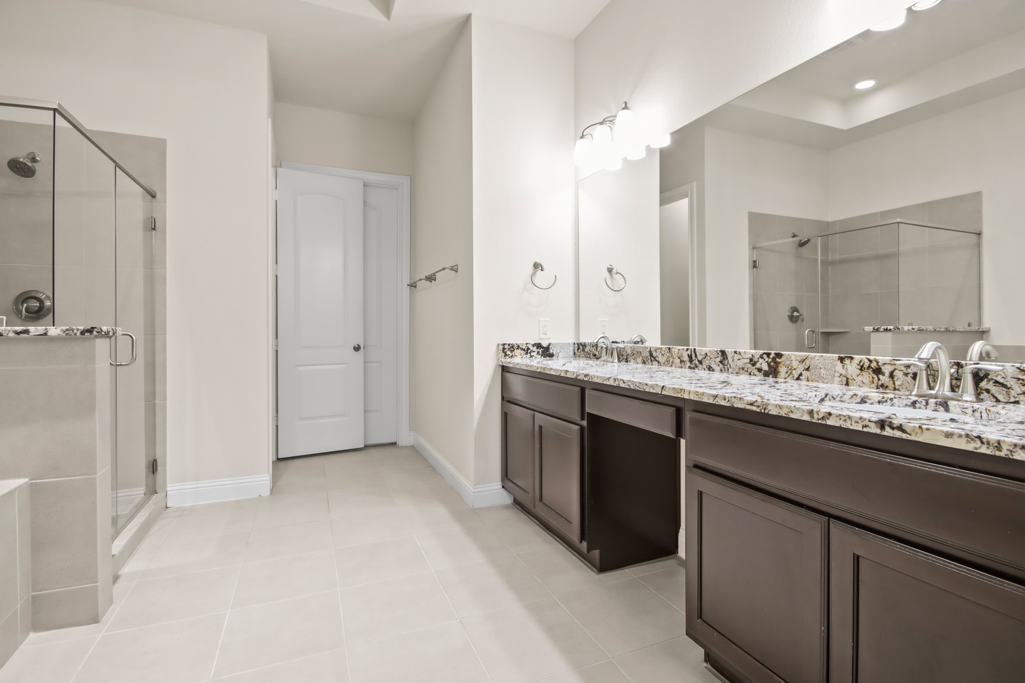 8931 Leaning Hollow Lane Spring, TX 77379 - Photo 17 of 38 The Primary Bathroom has the same gorgeous granite as the kitchen, double vanity, elegant soaking tub and a stand alone shower.