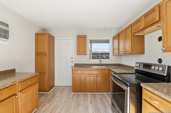 a kitchen with a sink stove and refrigerator