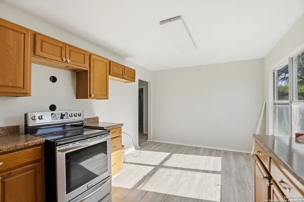 a kitchen with granite countertop a stove and a sink