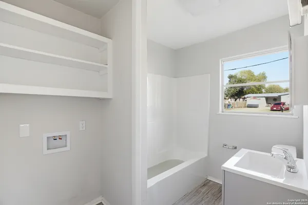 a bathroom with a bathtub and sink
