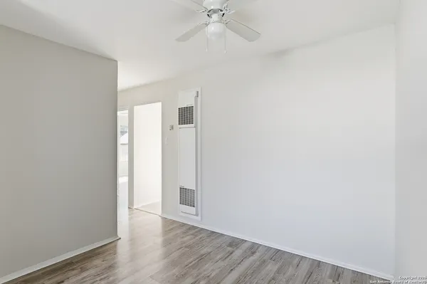 a view of an empty room with wooden floor