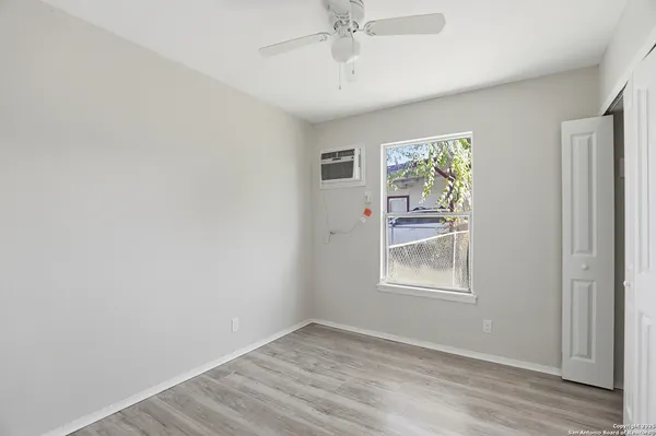 an empty room with windows and closet